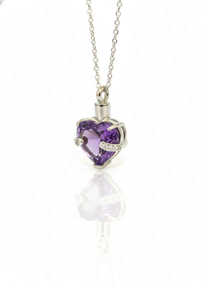 Heart-shaped purple gemstone pendant on a chain against a white background