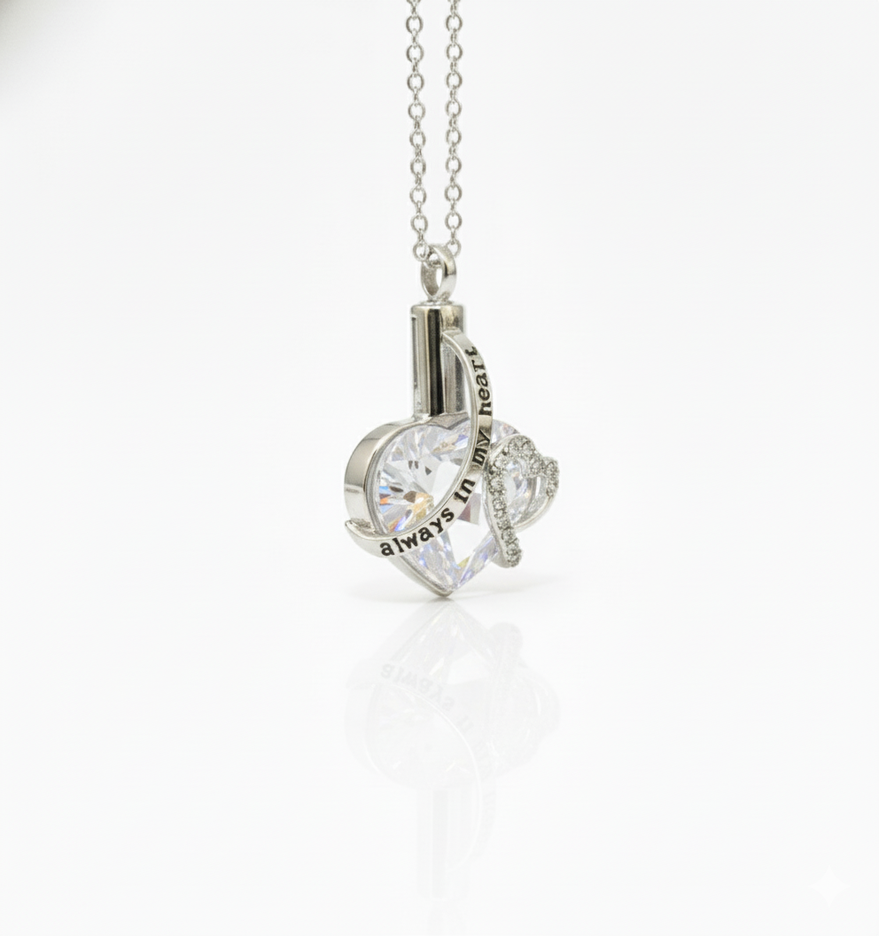 Heart-shaped silver pendant with chain on a white background