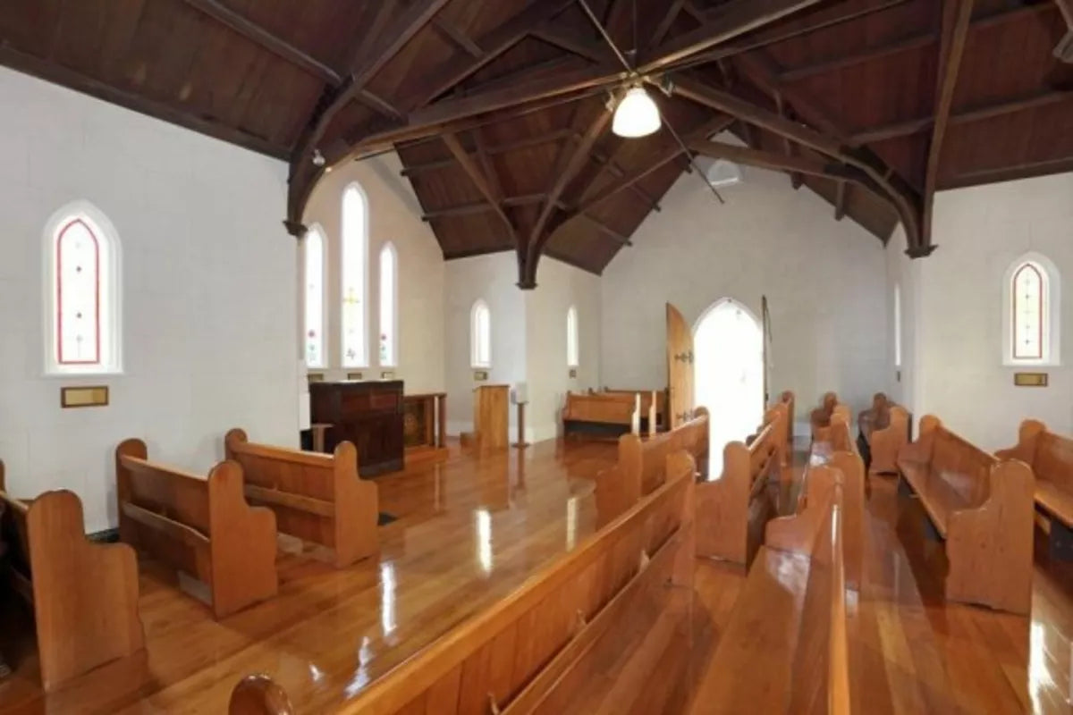 Interior of a church of faith in the oaks at waikumete cemetery with wooden pews and high ceiling