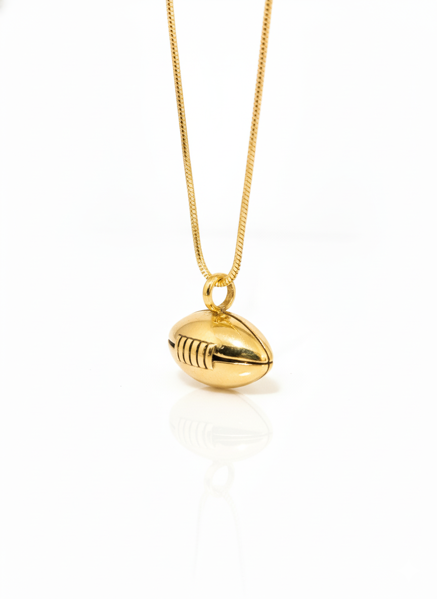 Gold football-shaped pendant on a chain against a white background