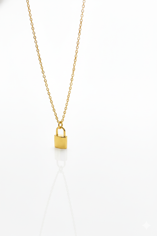 Gold necklace with a lock pendant on a white background