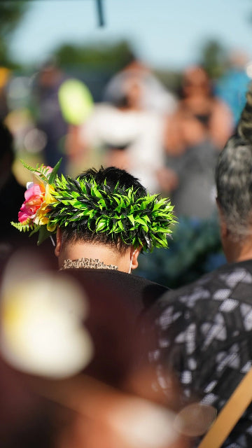 Person wearing a traditional Polynesian flower crown at a Pasifika funeral gathering in Auckland, supported by Lagoon View Funerals.
