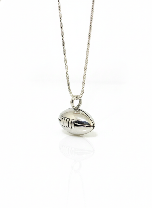 Silver football-shaped pendant on a chain against a white background